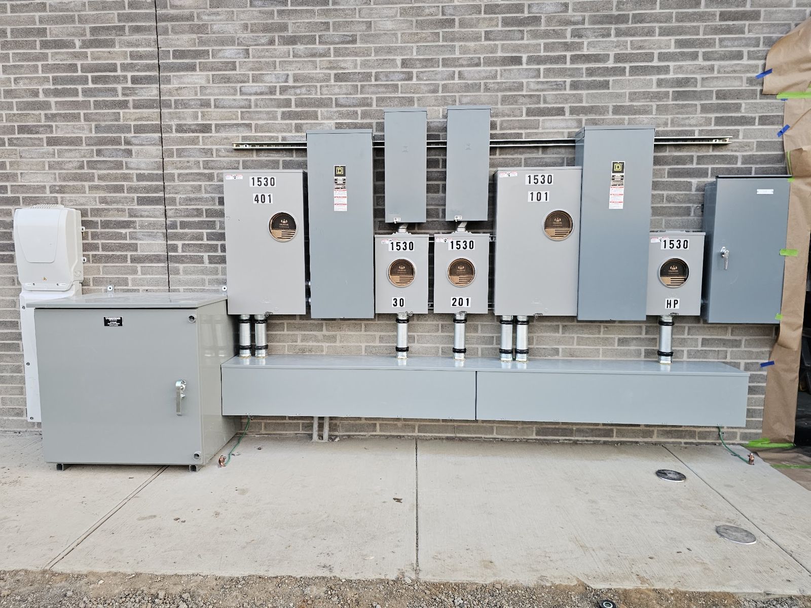 Multi-tenant commercial meter and disconnect bank with conduit risers