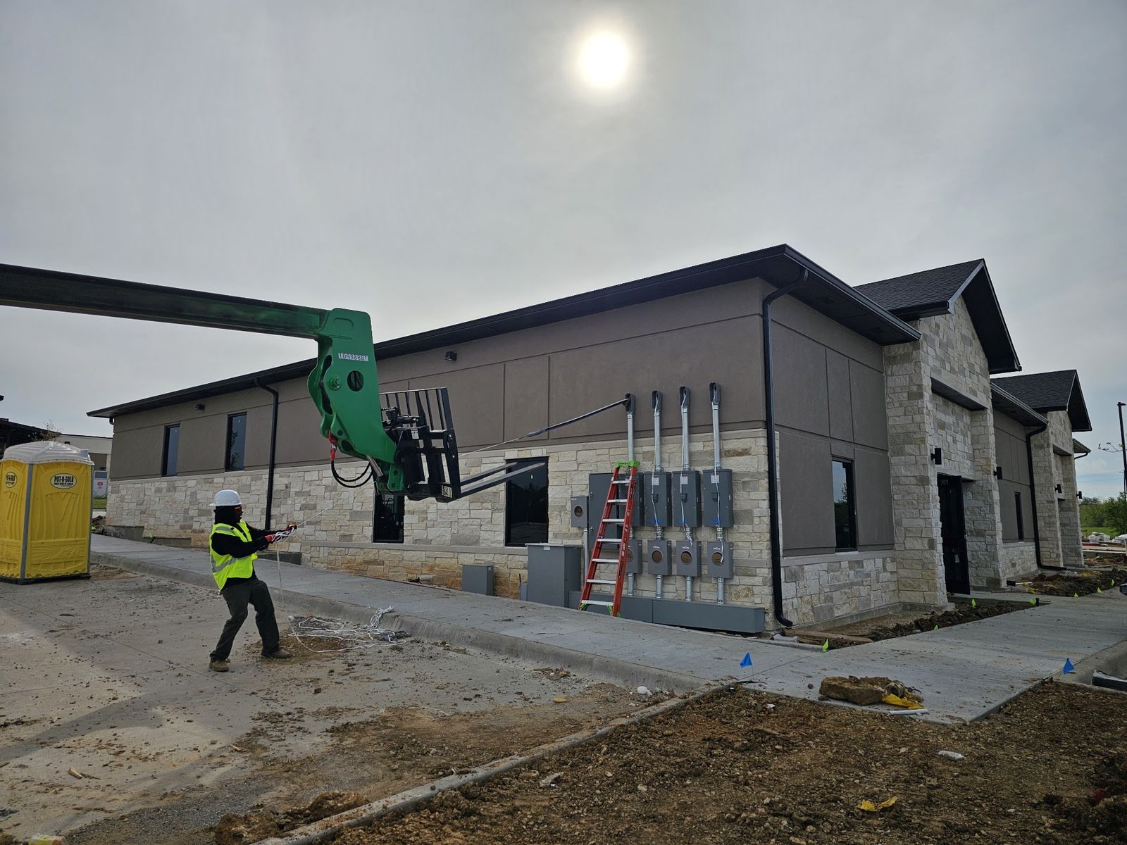 Commercial building under construction with electrical service equipment installed on the exterior wall