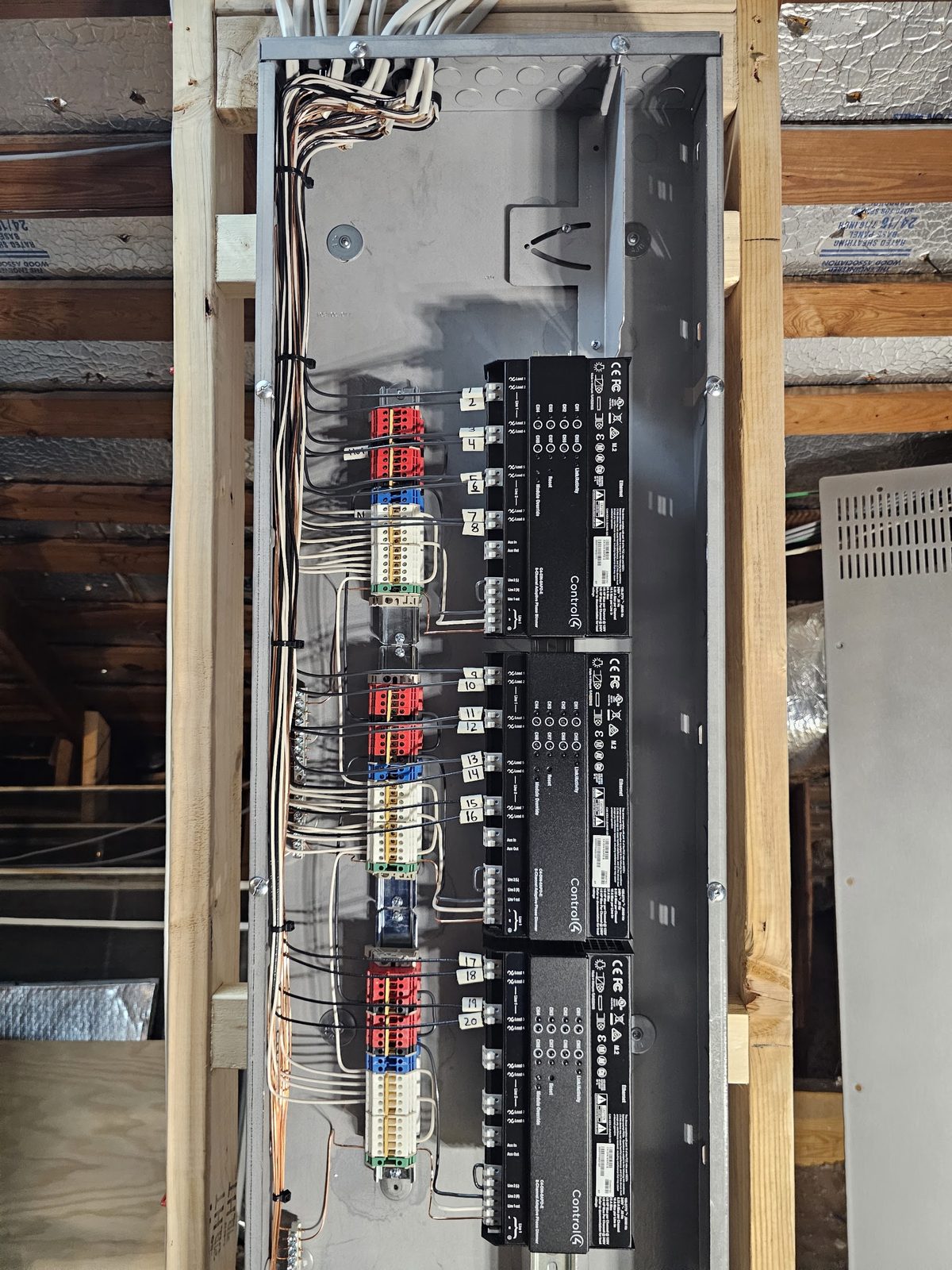Interior of a commercial lighting control panel with relays and neatly routed conductors