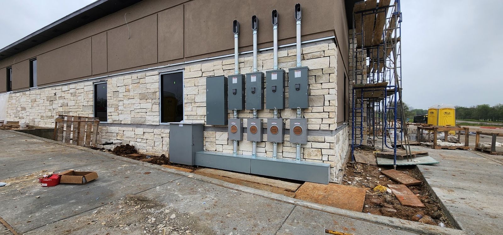 Commercial meter, disconnect and feeder installation along a building wall